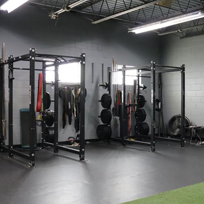 Wallace Fitness Center strength area with squat racks, free weights, and functional training equipment