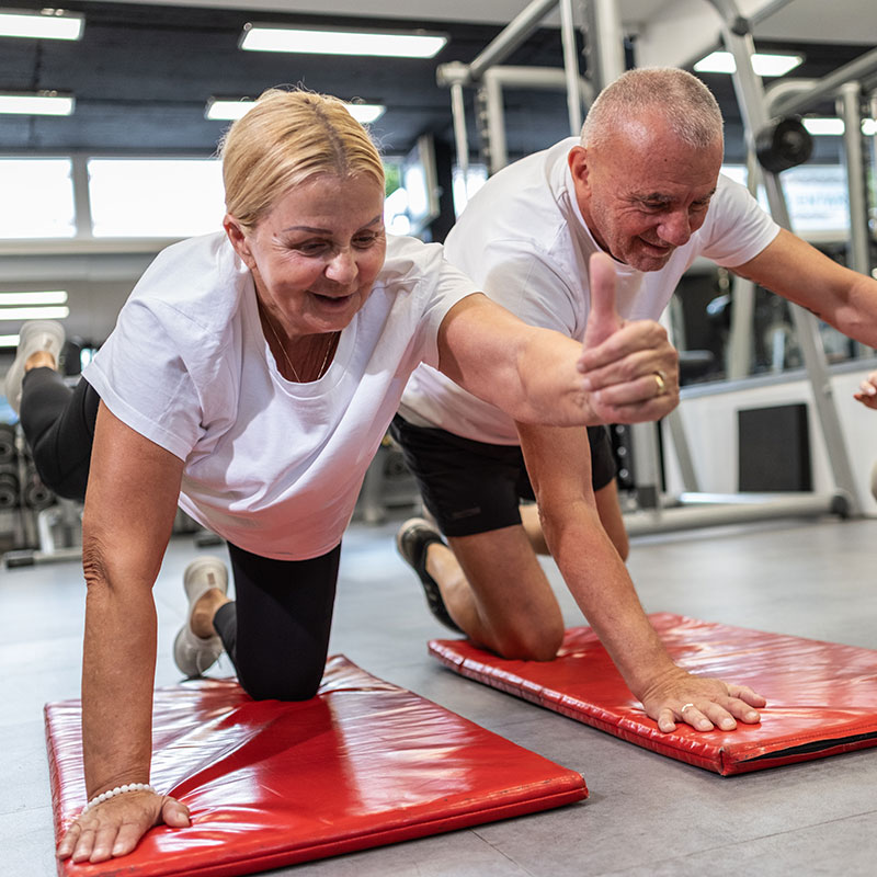 An elderly couple work on low-impact balance exercises during a Silver Sneakers session in Delmont, PA