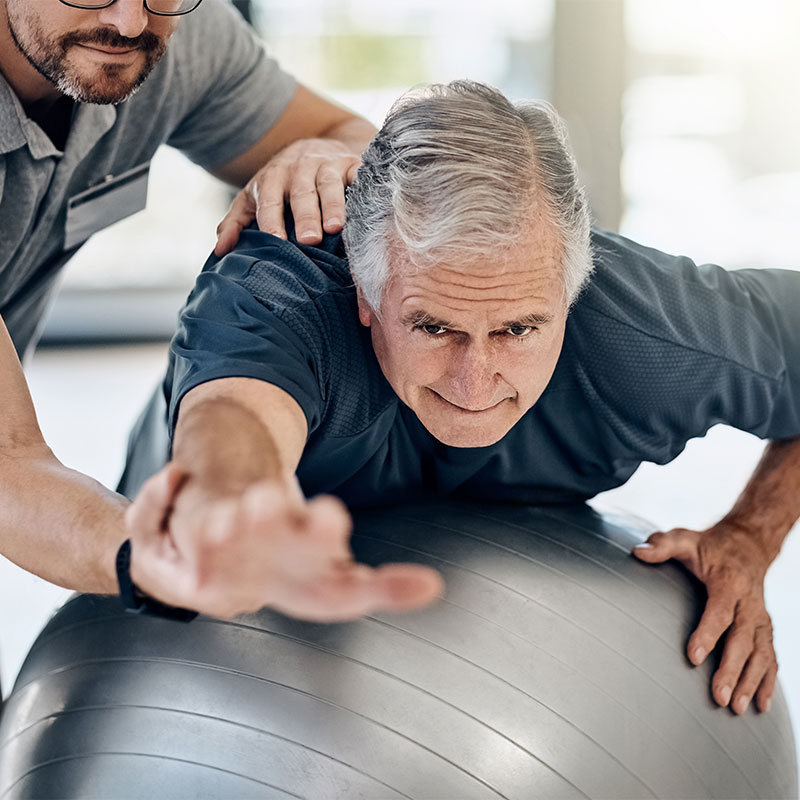 Man works on flexibility and balance during a Silver Sneakers session