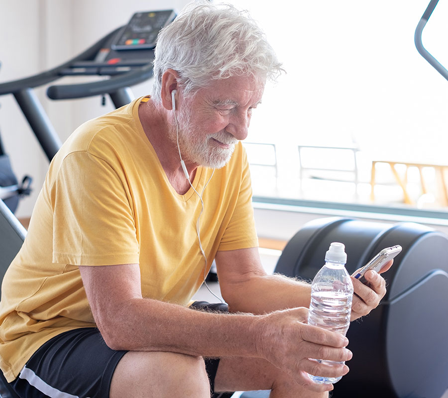A man recovers after light cardio during Silver Sneakers training