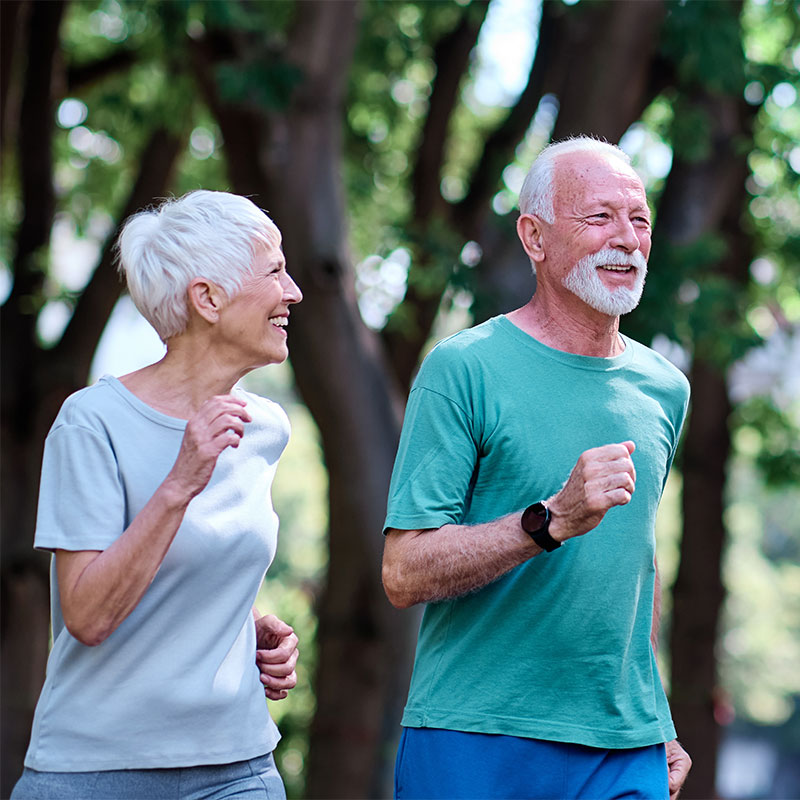 A couple walks in the park experiencing the benefits of more energy after training at Wallace Fitness center in Delmont, PA